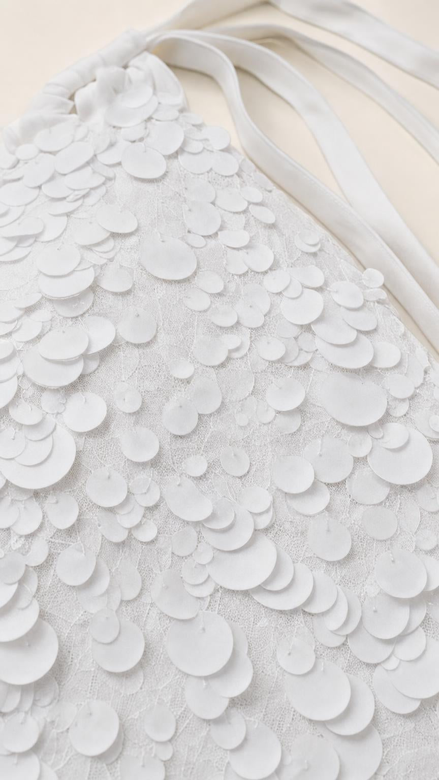 Close-up detail of White 3D round petal appliques and straps