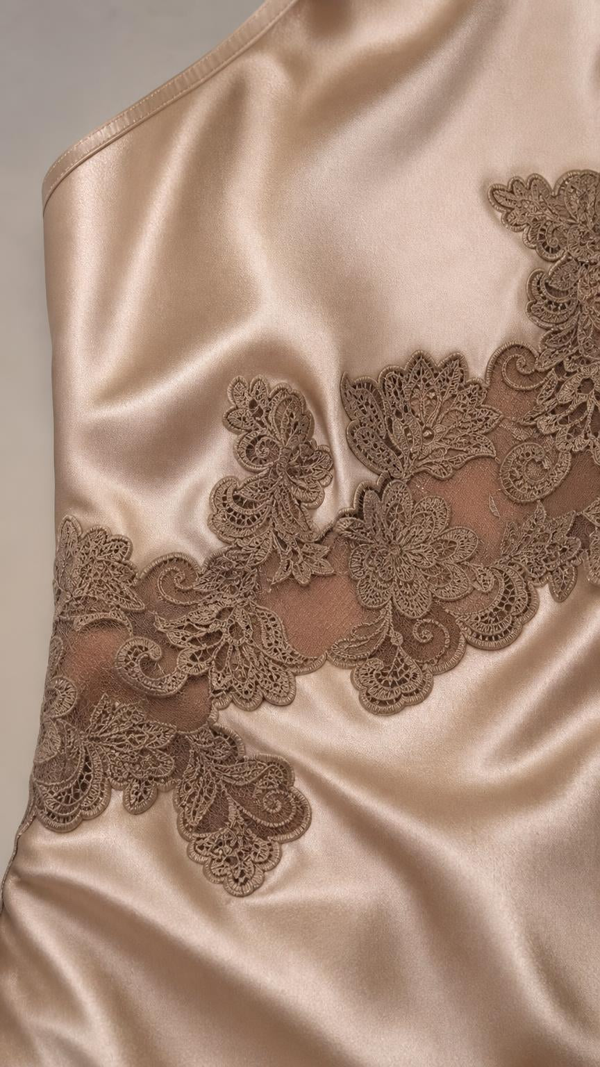 Close-up detail of lace applique and satin texture on dress