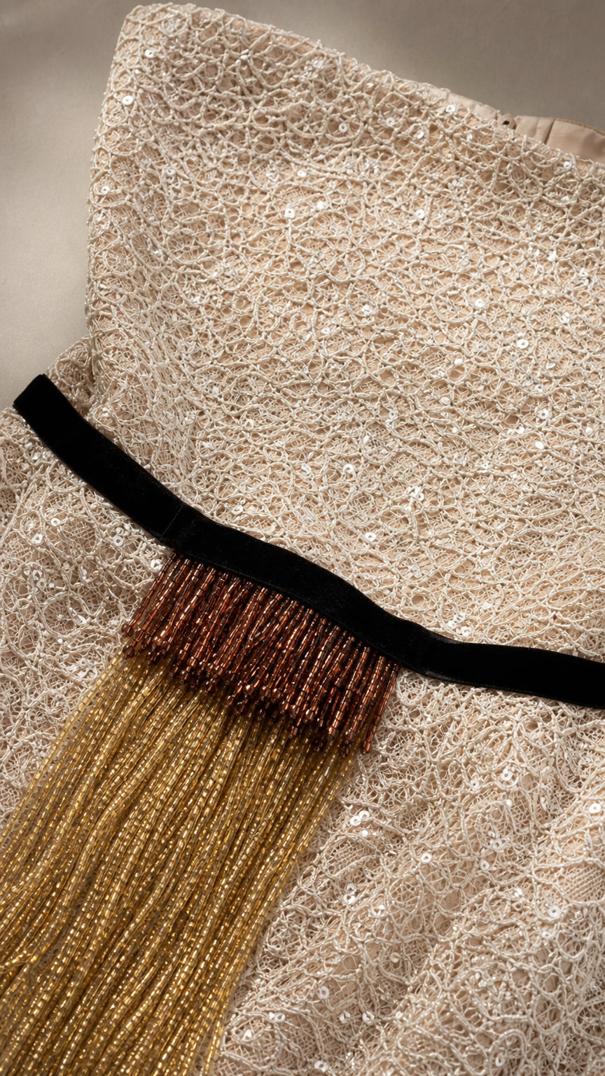Close-up of beaded texture and waist fringe detail