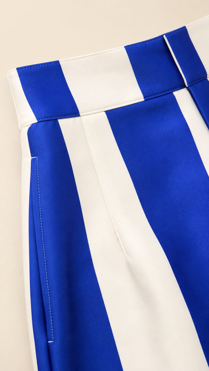 Close-up of waistband and stripe detail on blue pants