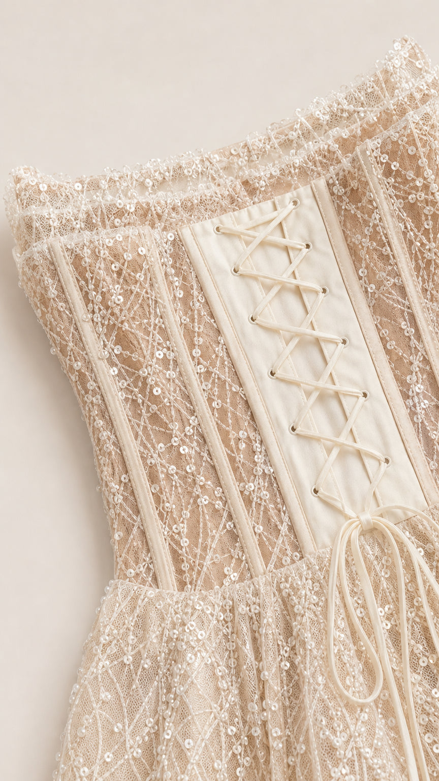 Close-up of the textured sequin bodice and lace-up back