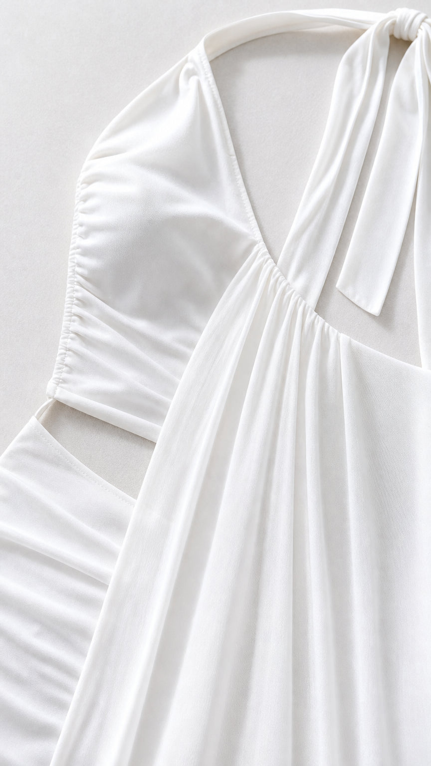 Close-up detail of white fabric, bodice, and cutout construction