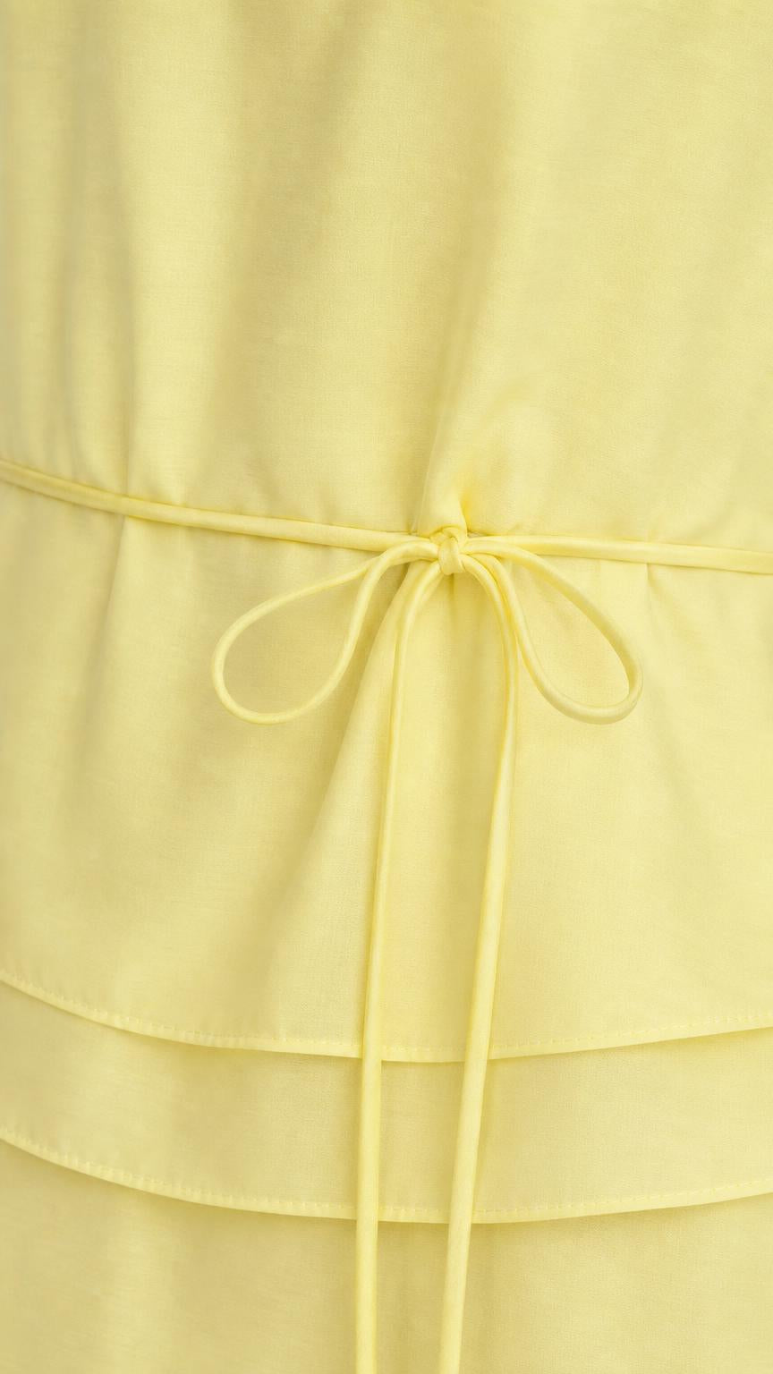 Close-up of drawstring waist detail on yellow maxi dress