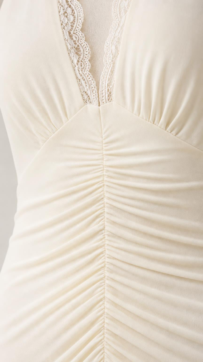 Close-up detail of the lace-trimmed V-neckline and center ruching
