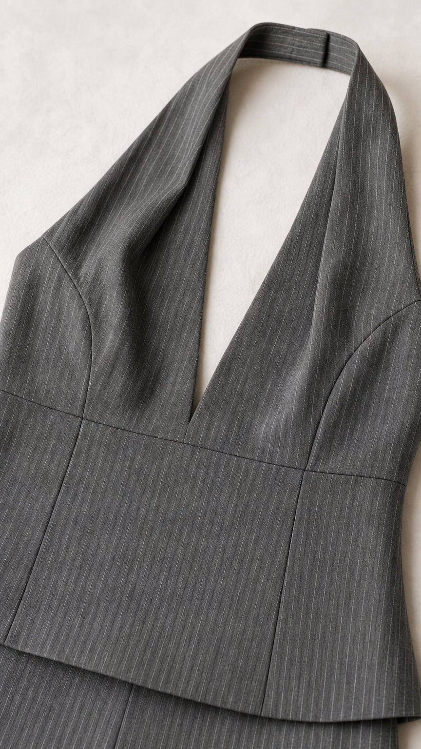 Close up detail of grey pinstripe halter neckline and fabric texture