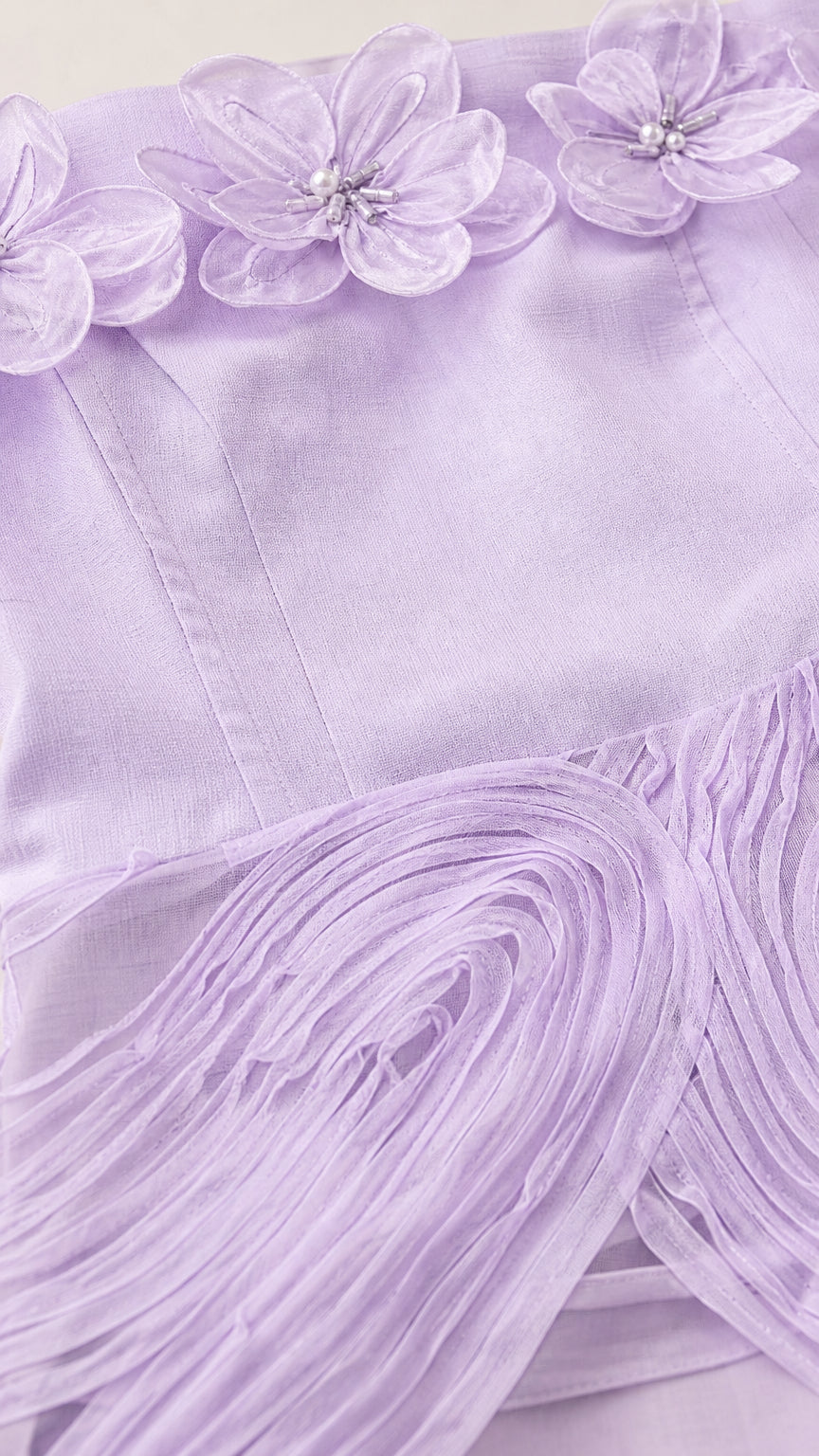 Close-up detail of 3D floral appliques and bodice on lavender dress