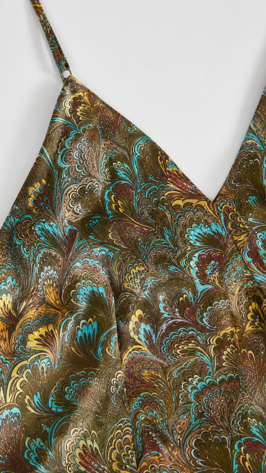 Close-up detail of the fabric pattern and V-neckline