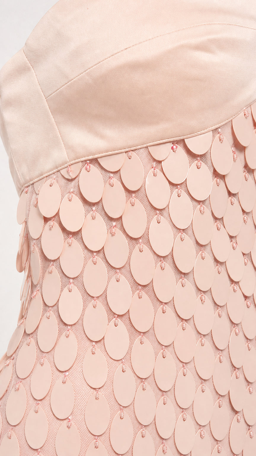 Close-up detail of the bodice and textured circular sequins
