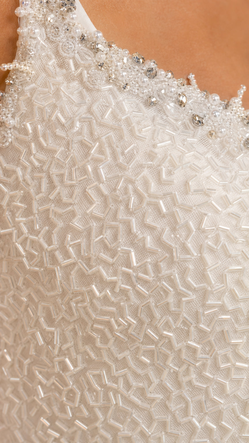 Close-up detail of crystal neckline embellishment and geometric beading