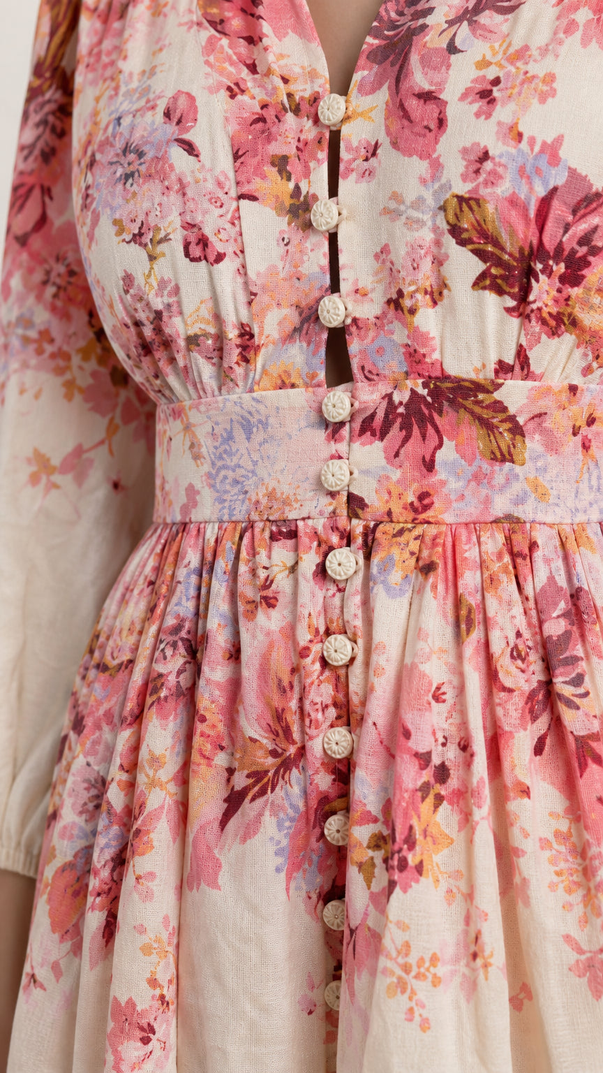 Close-up detail of buttons and fabric on floral mini dress