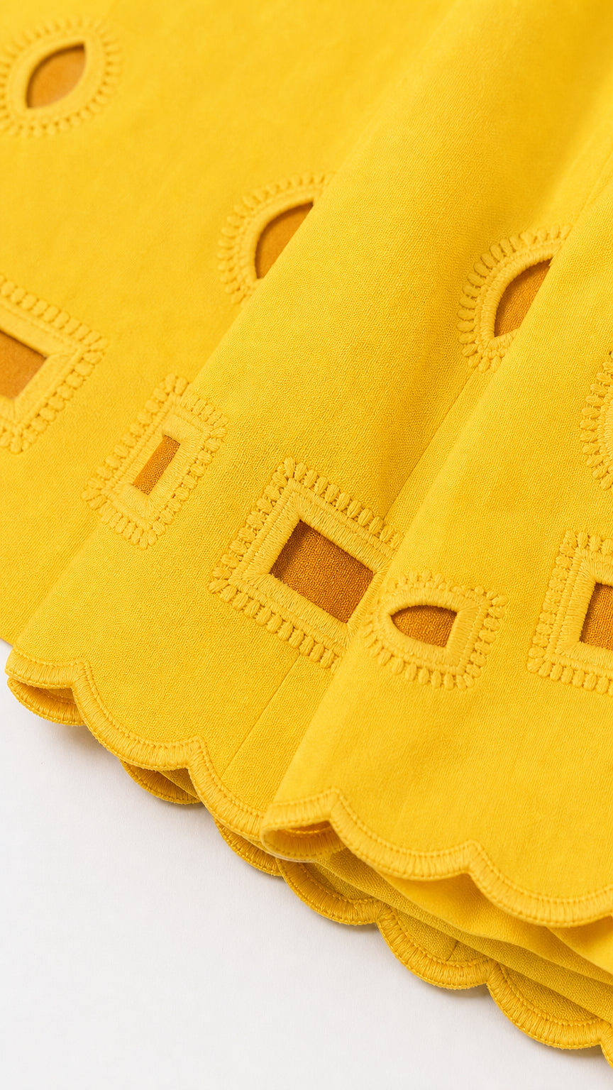 Close-up of yellow fabric texture and cutout details