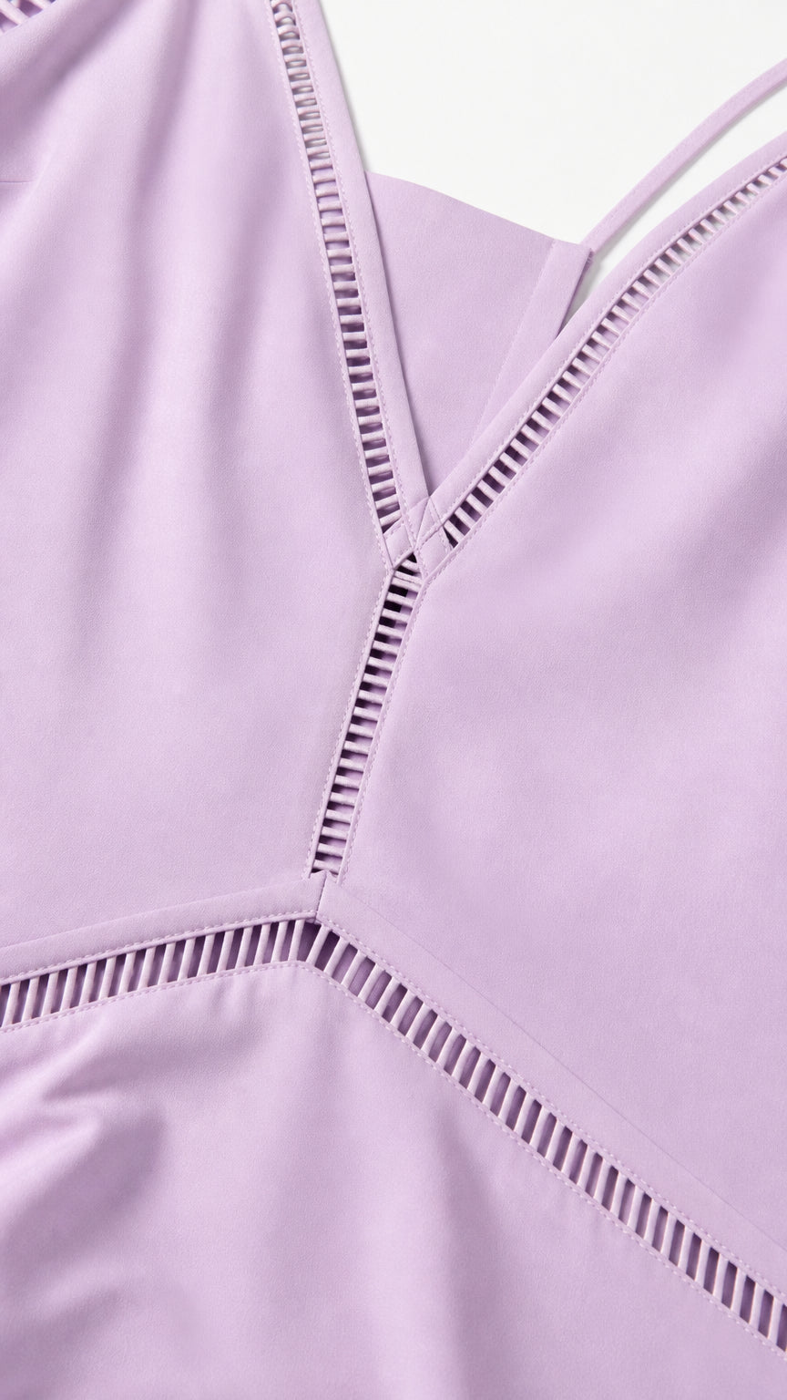 Close-up detail of V-neckline and ladder cutout trim