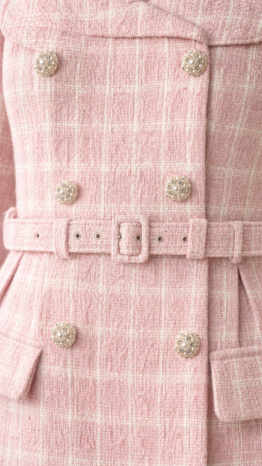 Close-up of buttons and belt detail on tweed dress