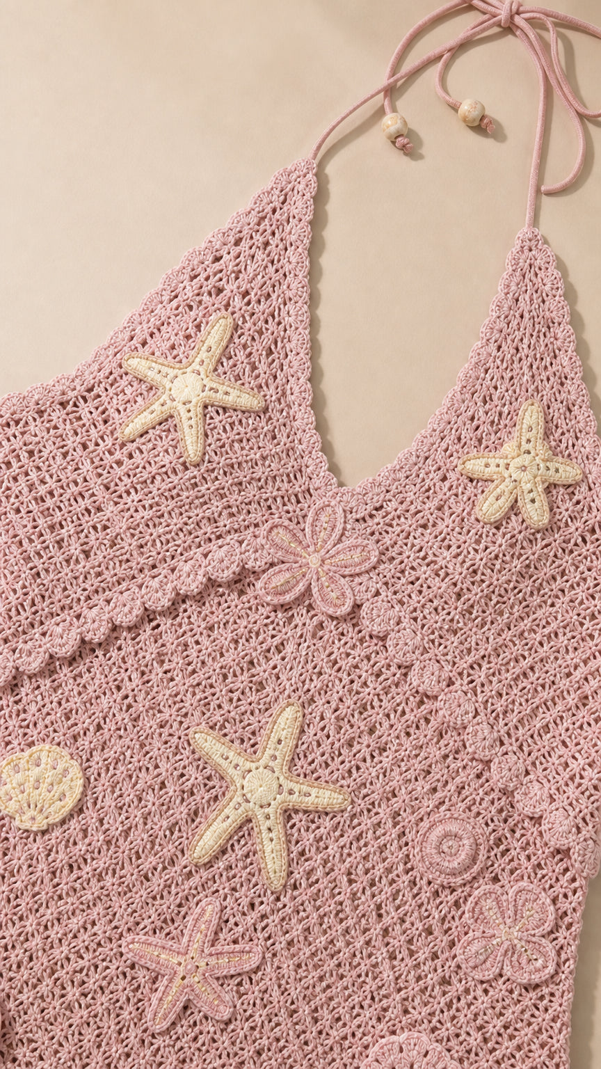 Close-up of pink crochet fabric and starfish appliqués