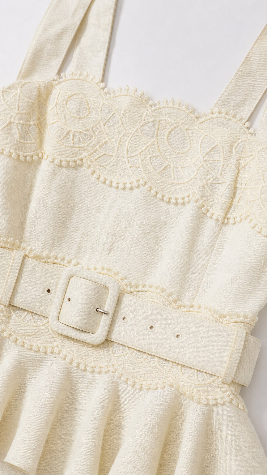 Close-up detail of square neckline and matching belt on yellow dress
