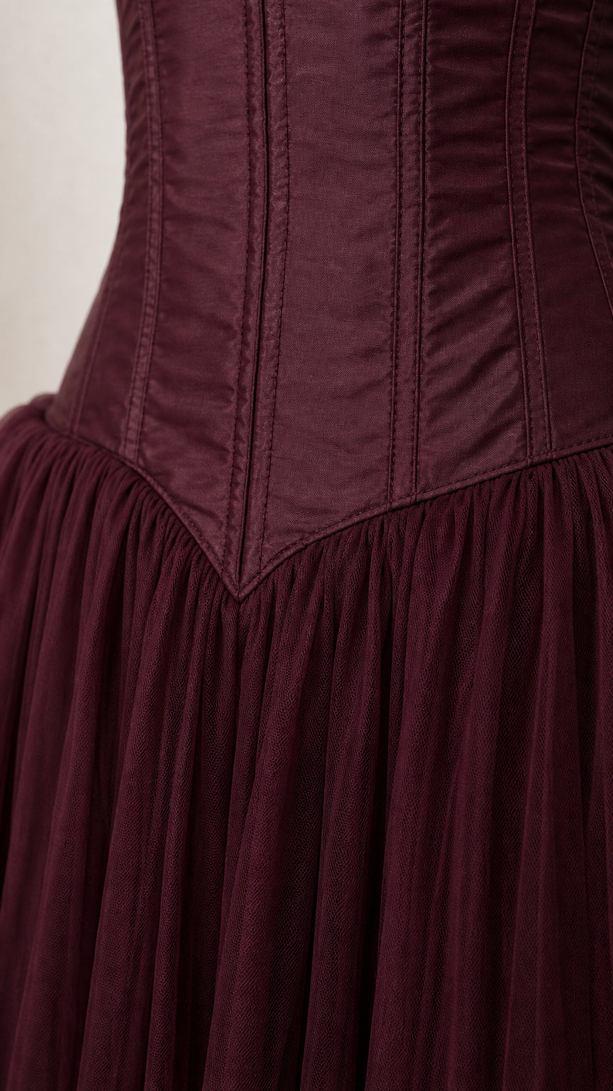 Close-up detail of the structured corset bodice and dropped waist seam
