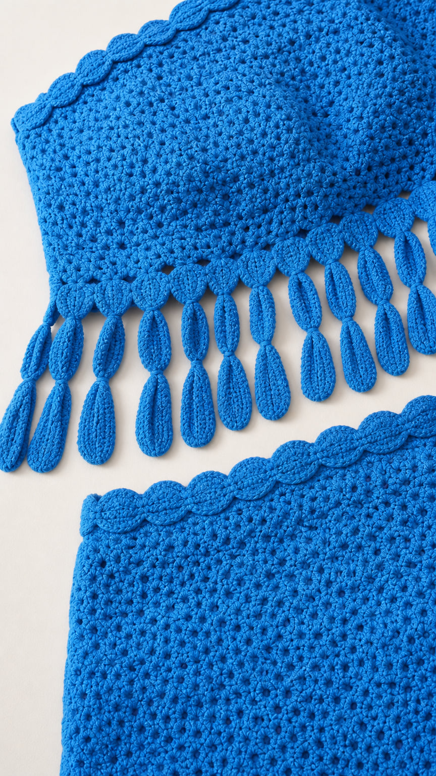 Close up of blue crochet crop top and skirt details