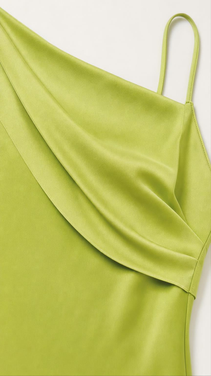 Close-up detail of one-shoulder cowl drape in lime green