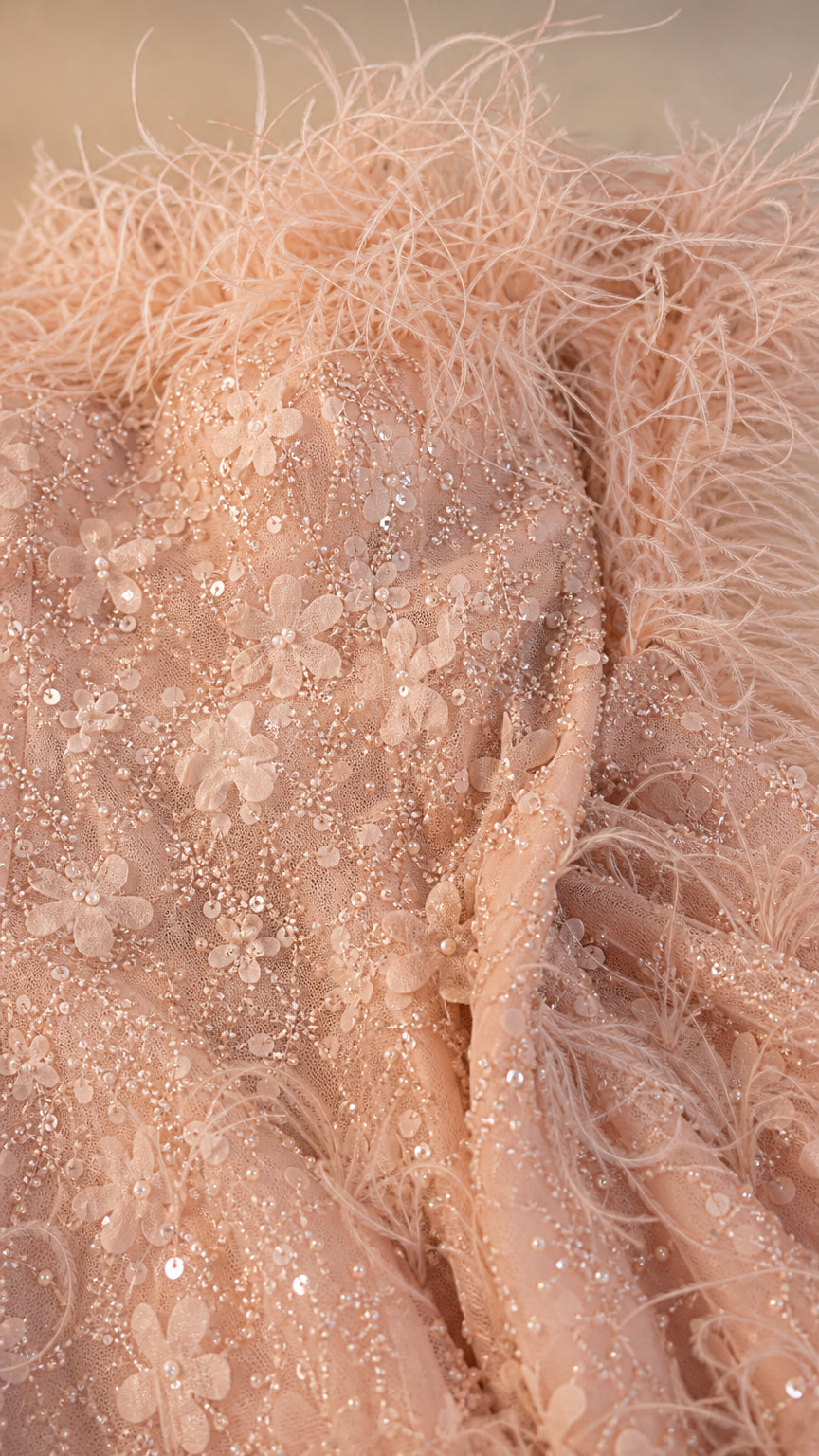 Close-up of feather trim, sequins, and floral lace details