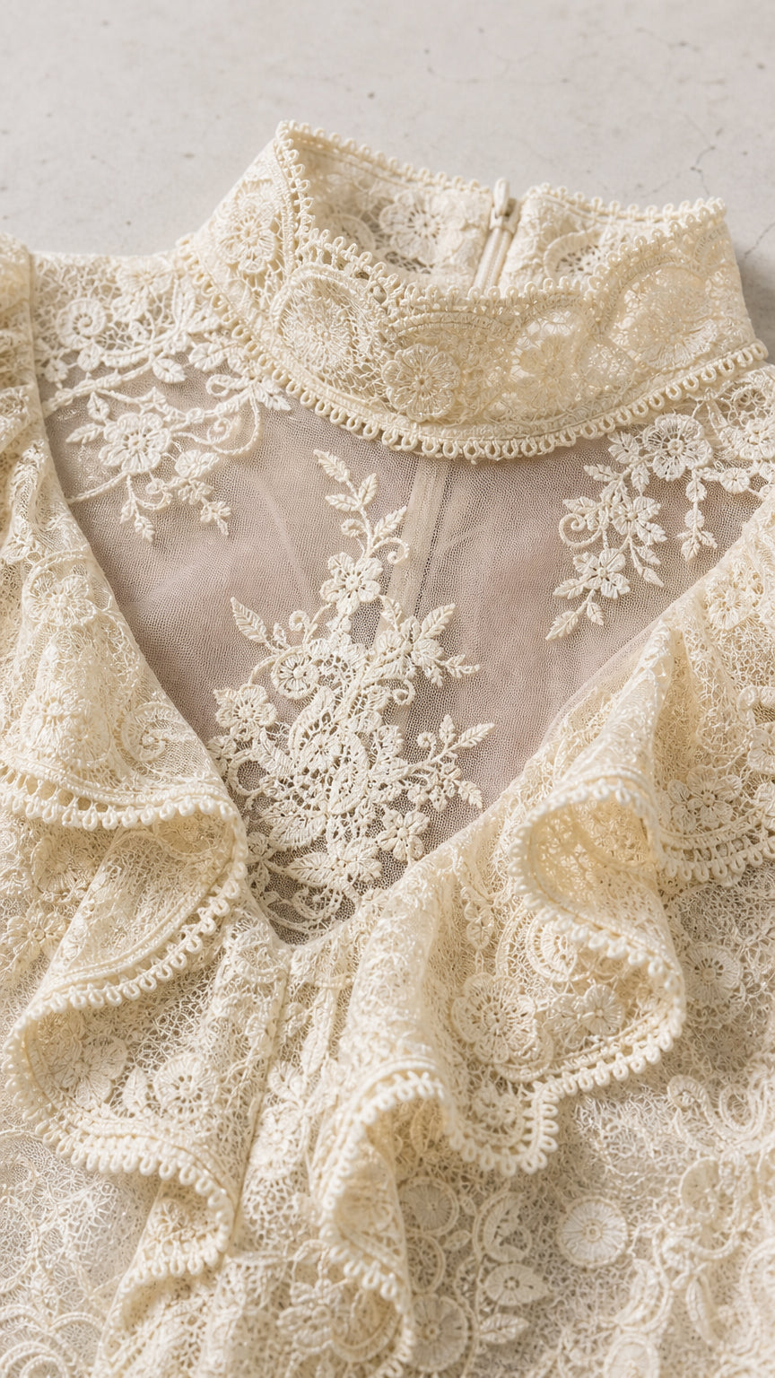 Close-up detail of ivory lace mock neck and ruffles