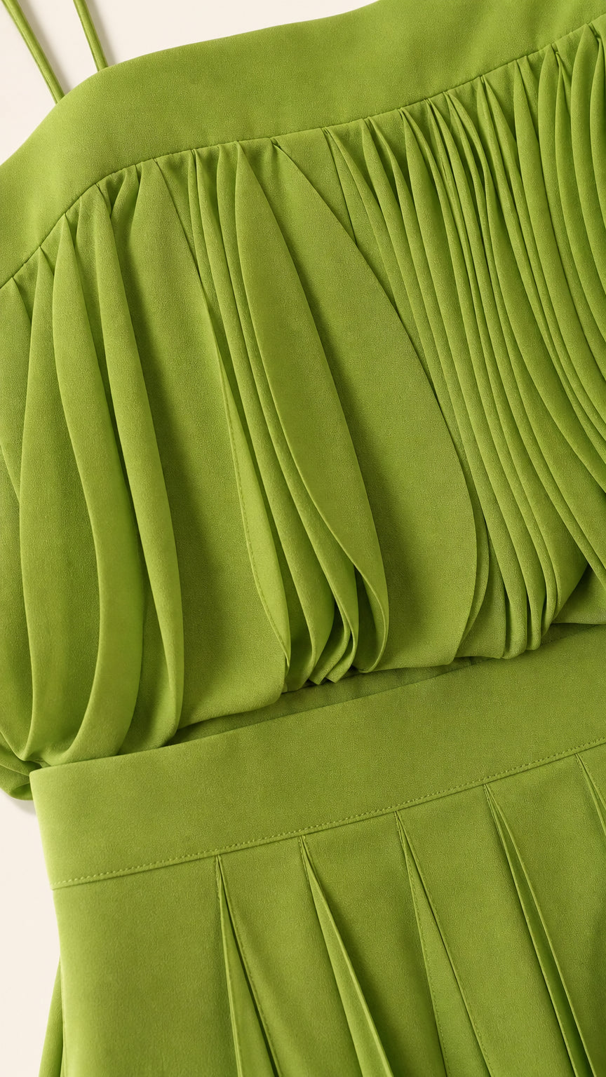Close-up detail of pleated cami top texture in green